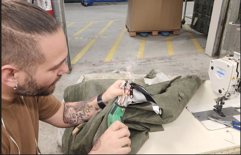 Jamie Whelan working at a sewing bench in his workshop